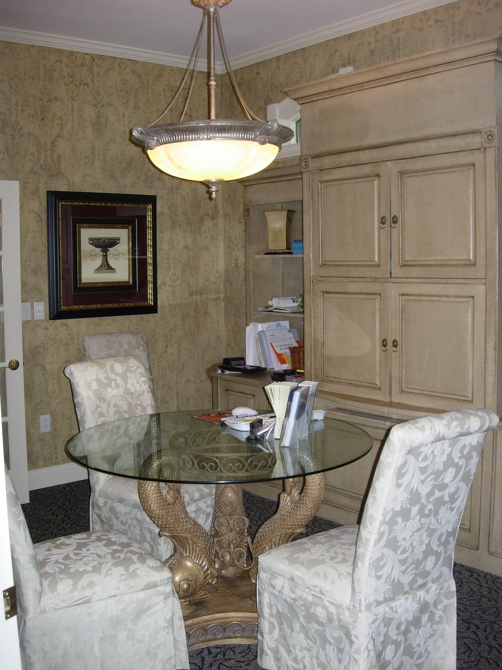 Private consultation room with glass-top table and classic furnishings at Thomas H. Pitts DMD